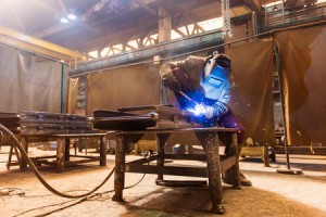 39484833 - young man with protective mask welding in a factory